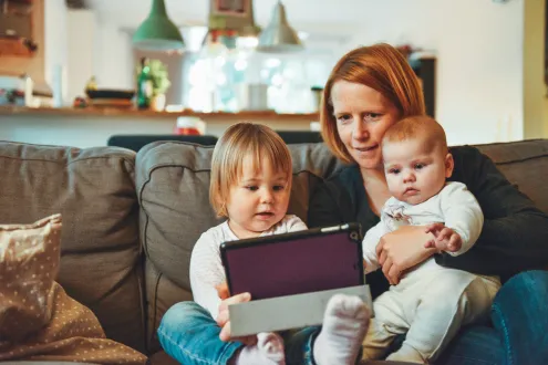 Young mum and her two children reading