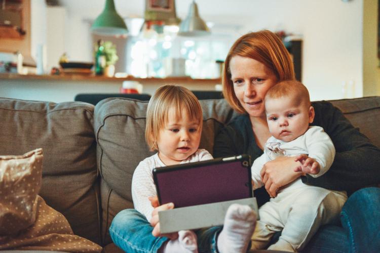 Young mum and her two children reading