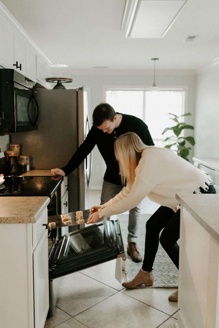 Two young people look how to use an oven