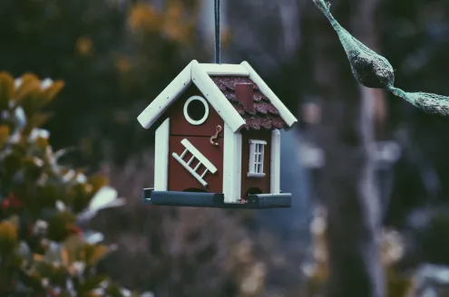 A bird house that looks like a new home