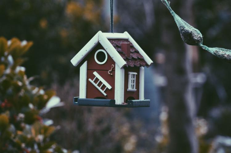 A bird house that looks like a new home